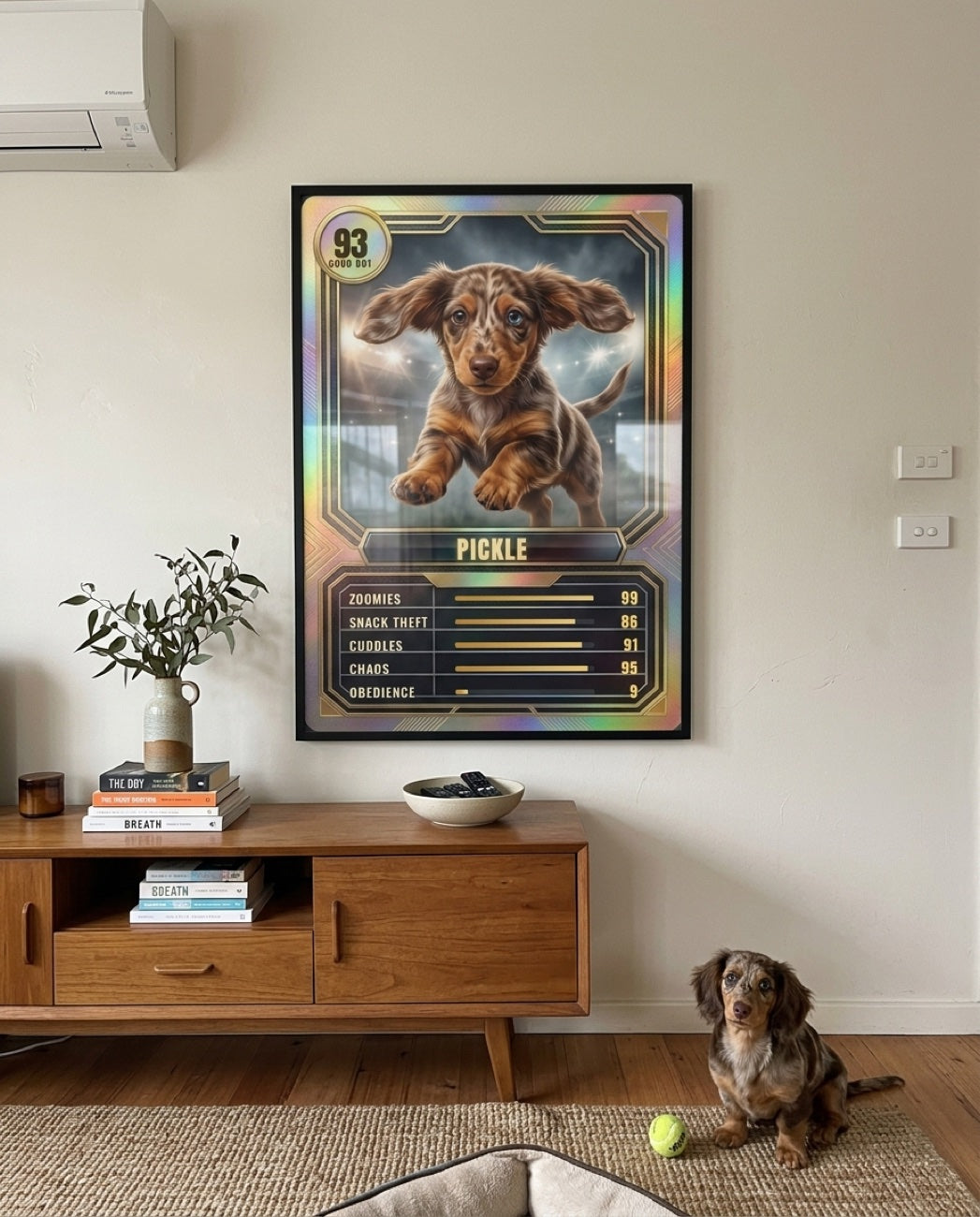 Framed Holo Legend Card hung above a sideboard with the dachshund on the floor